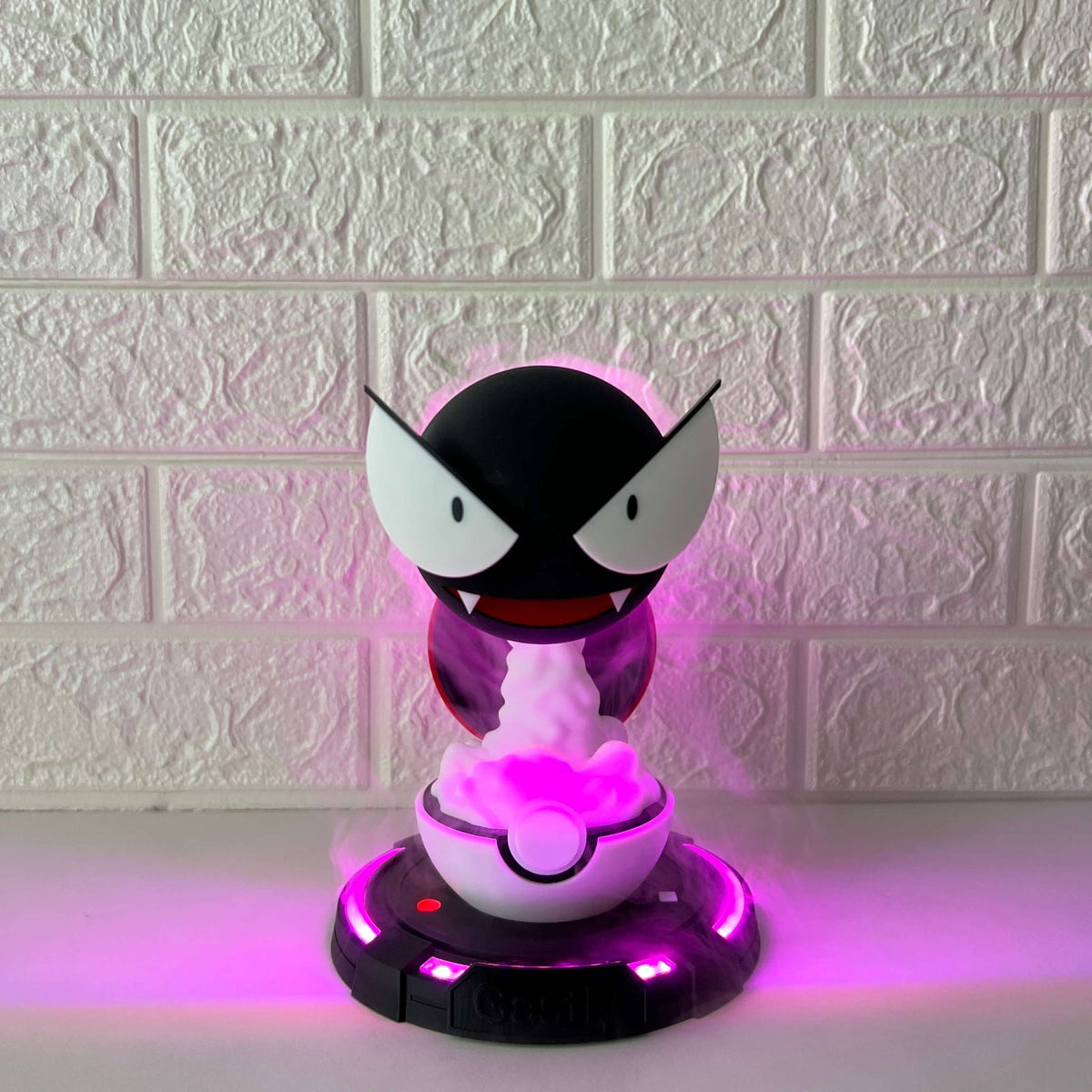 Front photo of Gastly-inspired cool mist humidifier with purple LED glow and visible mist on desk