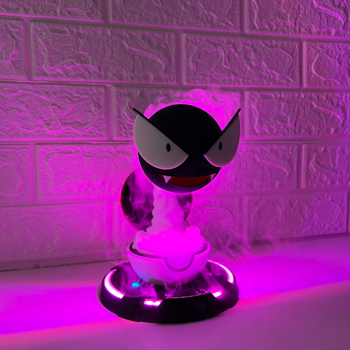 Angled view of Gastly-inspired cool mist humidifier showing swirling mist and purple LED base lighting